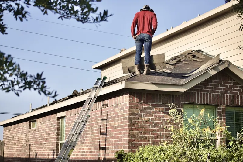 Professional roofer working on a residential roof in Pheasant Knoll